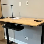 A desk with a laptop and lamp on it.
