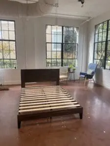 Bright, neatly arranged bedroom with natural light, demonstrating our attention to detail in furniture assembly and window treatment services.