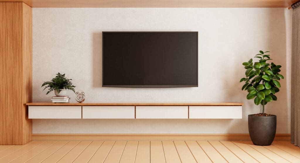 TV above wooden cabinet