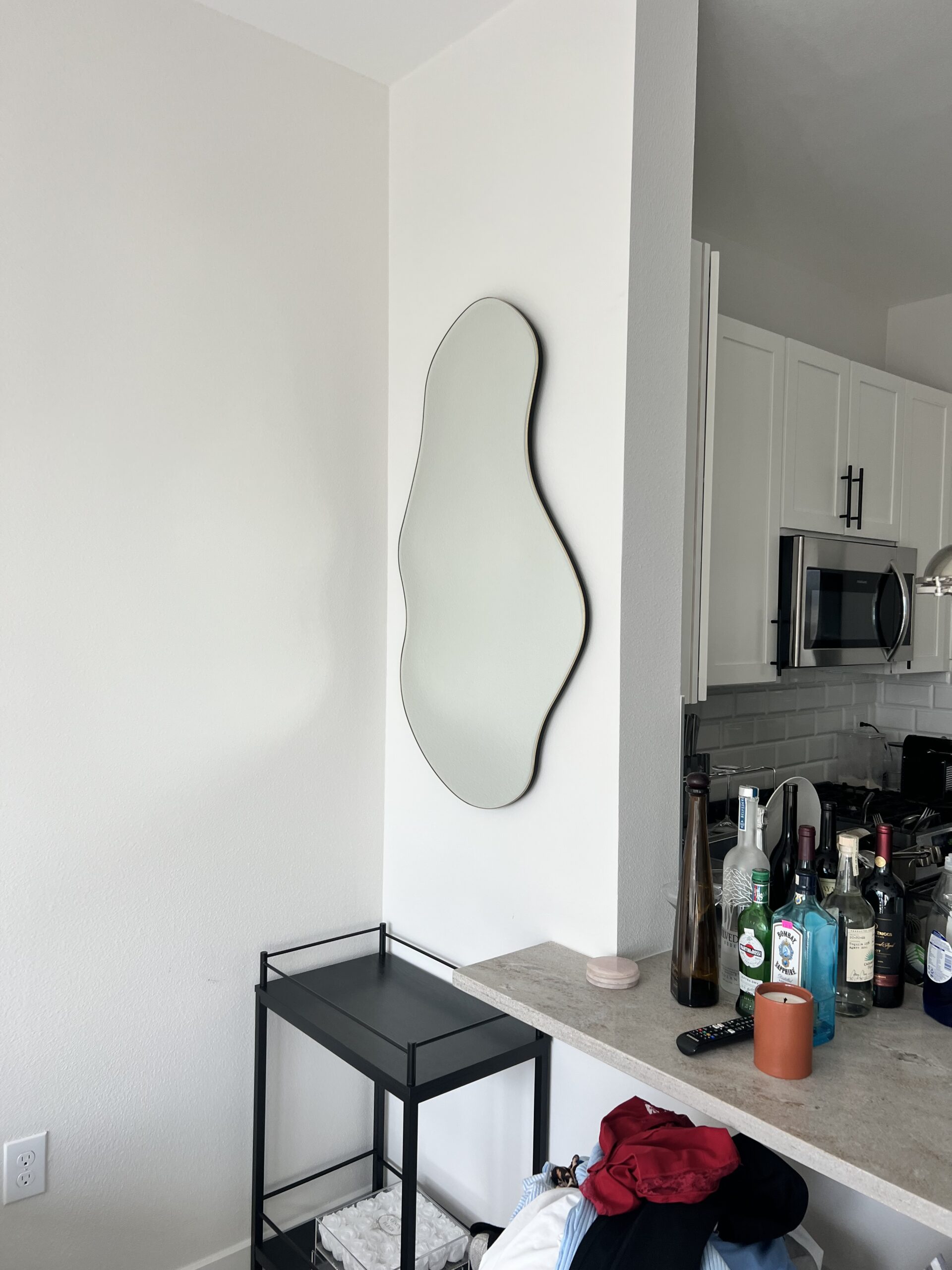 Irregularly shaped mirror installed in a unique space, offering custom design solutions.