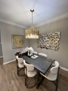 Elegant dining room design with a custom mirror installation, enhancing the room's atmosphere.