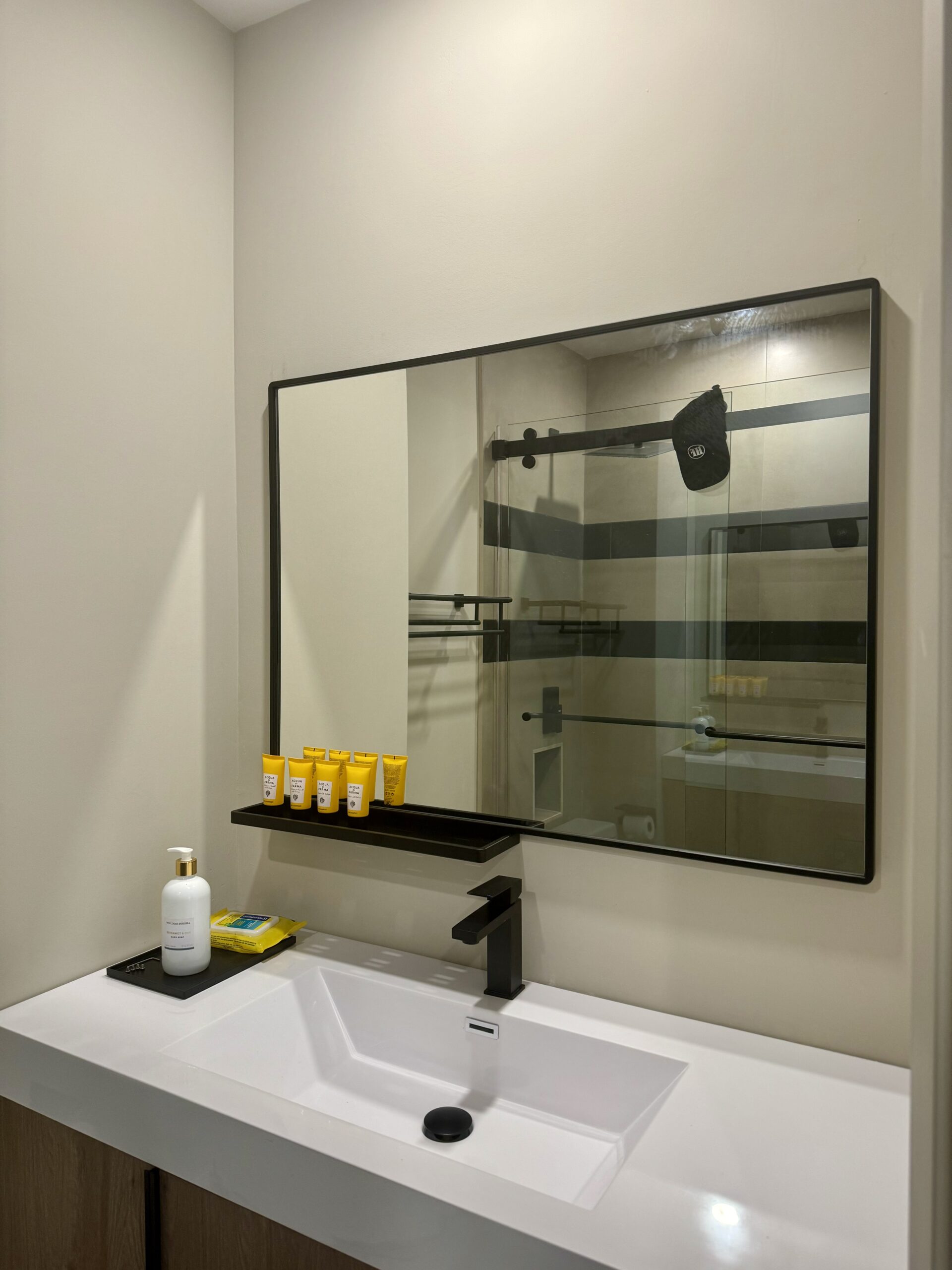 Bathroom featuring a large mirror with a sleek, modern design, installed professionally for maximum appeal.