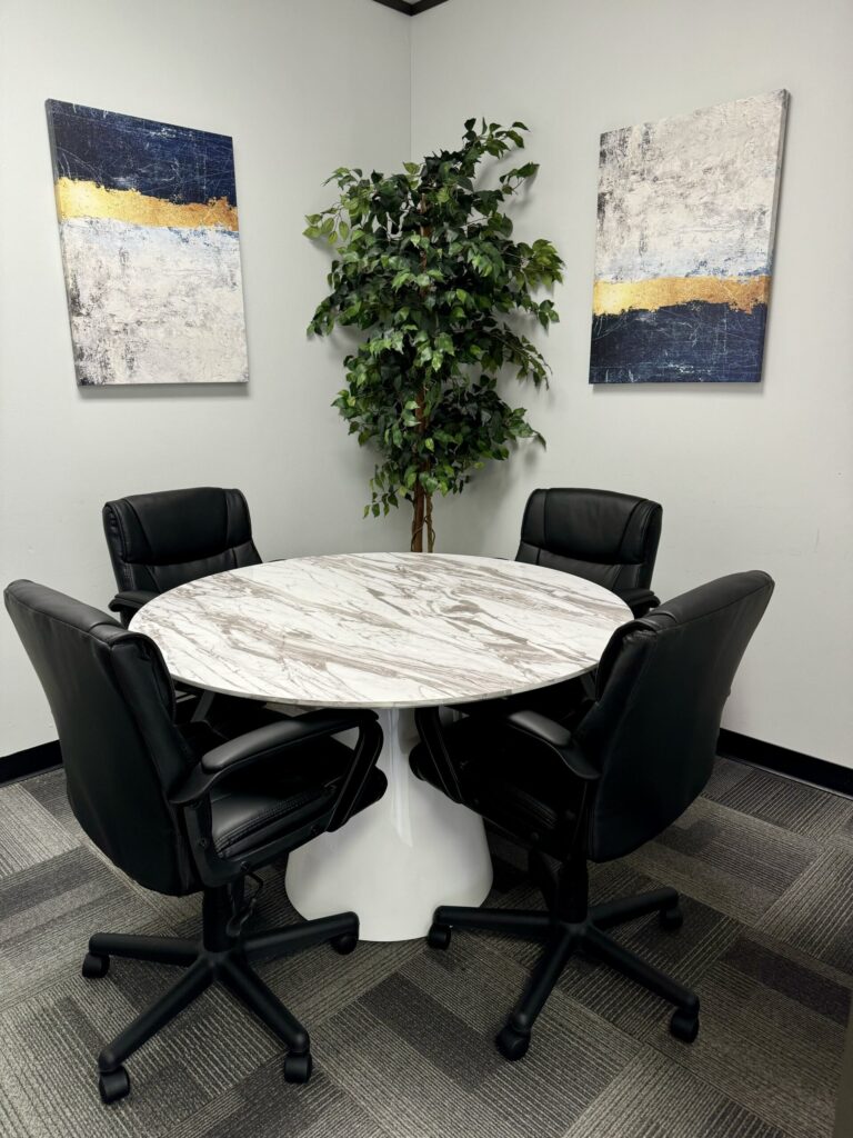 Modern meeting room furniture assembly in Houston featuring abstract wall art.