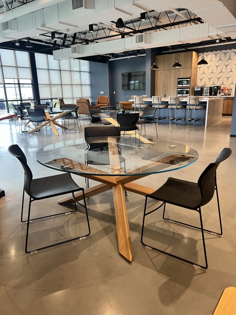 Commercial furniture assembly in Houston, showcasing a modern office space with a glass-topped round table.