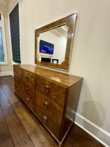 Stylish bedroom dresser with a custom ornate mirror, enhancing the decor through expert installation.