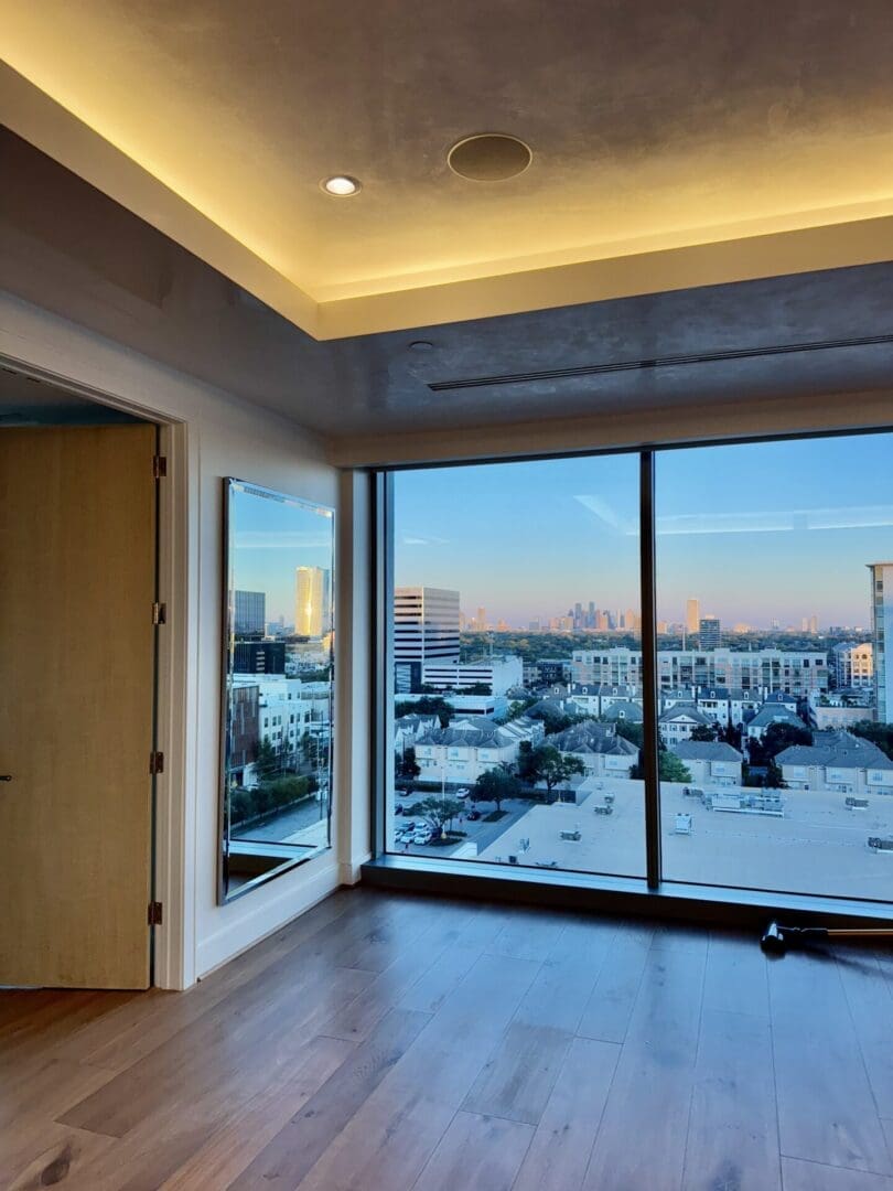 a room with a large window and a view of a city